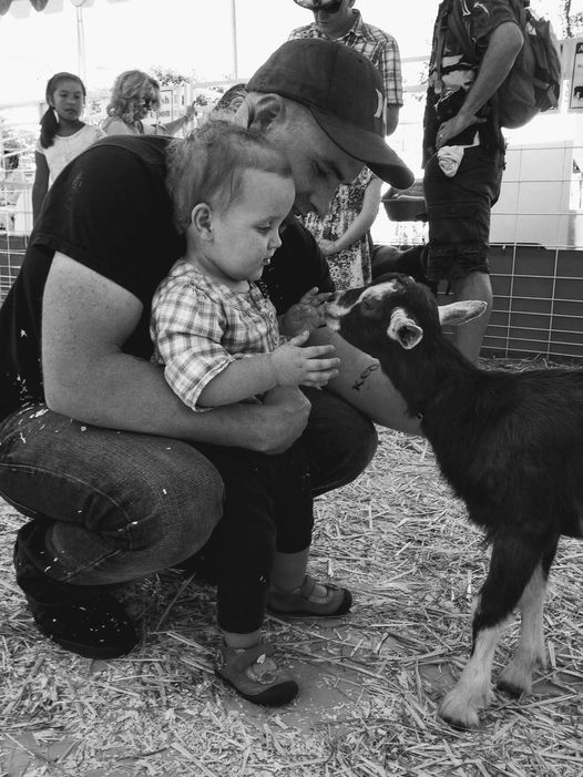 Dad and child with goat